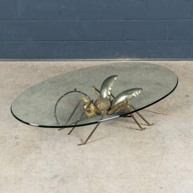 A rare and sculptural illuminating coffee table by henri fernandez, france, dating to circa 1970. This striking piece...