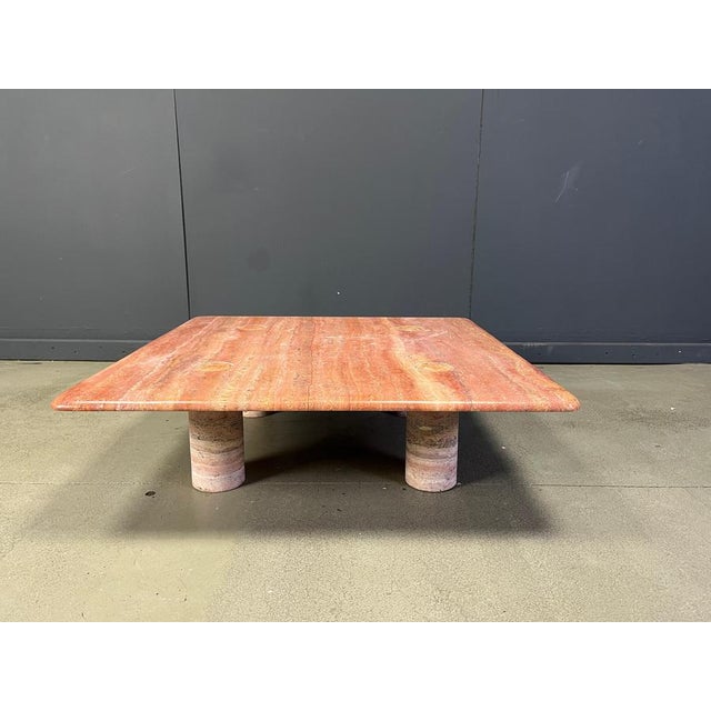 Rare red travertine coffee table with interlocking legs designed by Angelo Mangiarotti for Up&Up. Gorgeous pink/red...