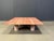 Rare red travertine coffee table with interlocking legs designed by Angelo Mangiarotti for Up&Up. Gorgeous pink/red...