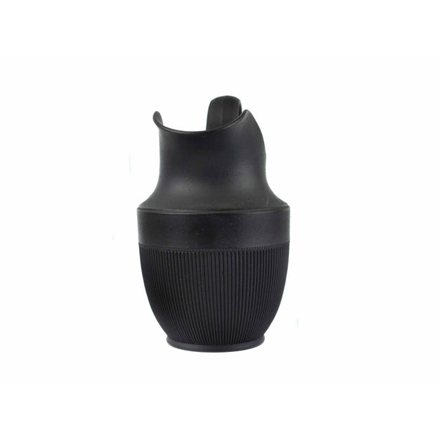 striking example of early post-war German modernism, this rare small "Mattschwarz" (matte black) basalt pitcher features...