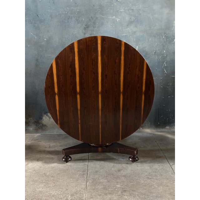 A striking example of an early 19th century English regency rosewood tilt top center table featuring a wonderful grain...
