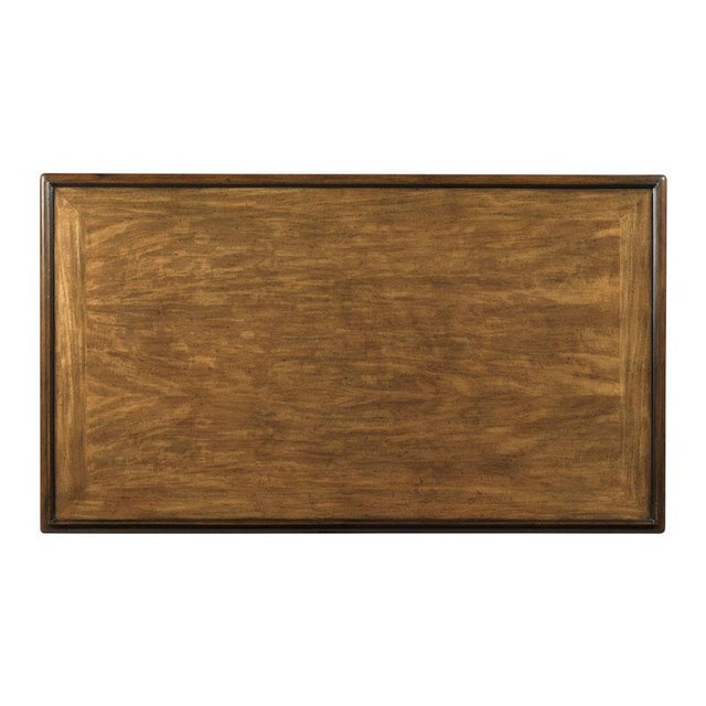 A molded rectangular top is elevated by stylized bamboo corner posts with intricate leather bindings joined by a low shelf.