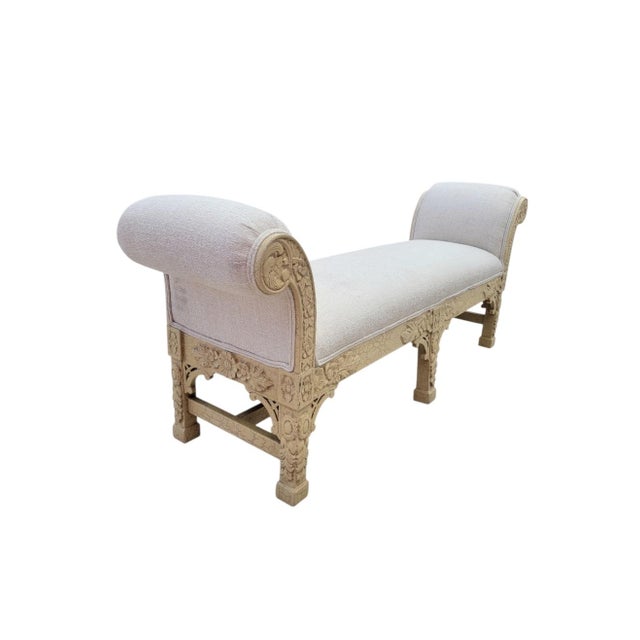 A gorgeous pair of highly carved baroque style upholstered hall benches. The benches feature a soft creamy deep margarine...