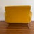 A vintage 1960’s loveseat. The chair features a curvaceous profile with swooping sheltering armrests and a pitched...