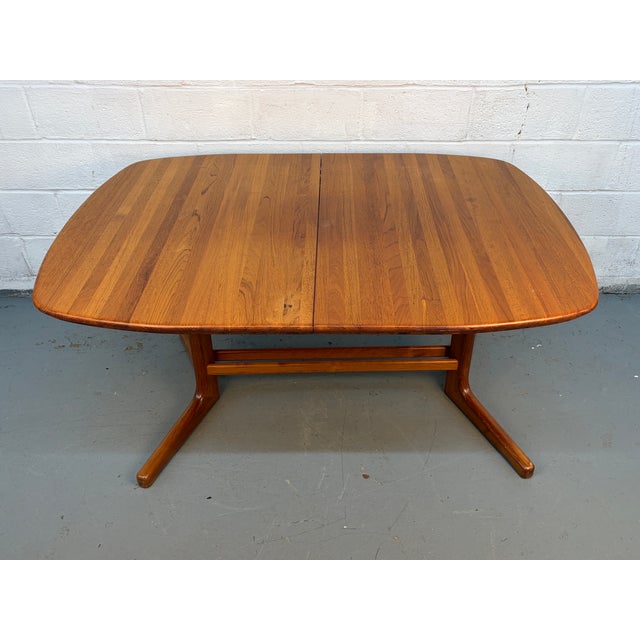 Add timeless Danish modern style and everyday versatility to your home with this vintage teak extension dining table by...