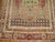 an early 20th-century intermediate-size Turkish Ghiordes rug with a scroll prayer niche design commonly found in smaller...