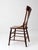 A 19th century American splat back chair featuring a warm aged wood finish and classic farmhouse form. The chair is...