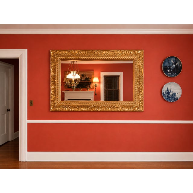 Absolutely stunning large carved giltwood mirror, probably of Italian origins, measuring 68.25" wide and 46.25" high as...