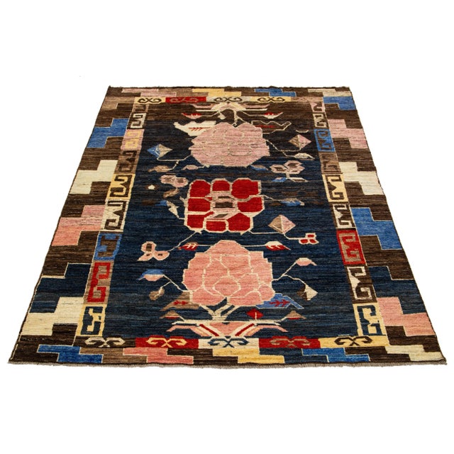 This wool rug showcases a modern take on the Moroccan style, boasting a beautiful navy blue color field. The rug features...