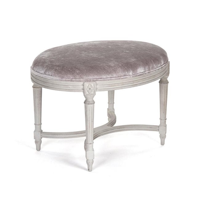 The Vita Stool from Zentique is a French country vanity stool with a grey-lavender velvet padded seat on a distressed off-...