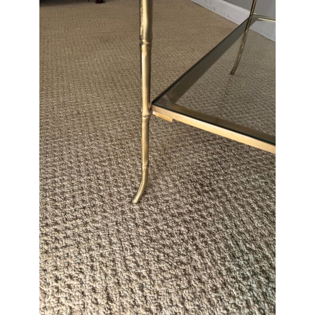 This glass & Brass side table with two Tiered shelves. With a satin glass Lacquer finish.