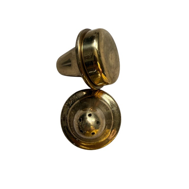 Add a warm, timeless touch to your table with this elegant pair of vintage solid brass salt and pepper shakers. Featuring...