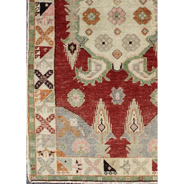1930s Vintage Turkish Oushak Rug With Deep Red Field and Soft Green and Peach Accents For Sale - Image 5 of 7