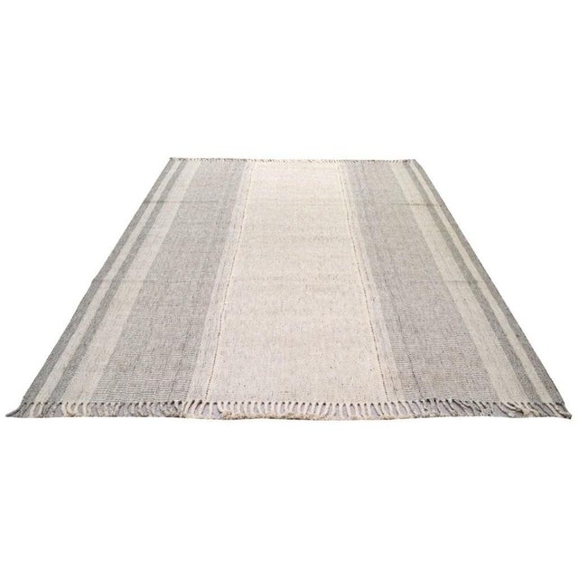 Hand-knotted with care using traditional rug making techniques, this wool rug blends timeless craftsmanship with a modern...