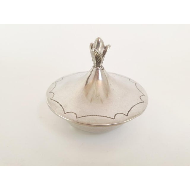 Elegant Swedish lidded pewter box from 1930, featuring a sculptural finial and delicate engraved detailing along the rim....