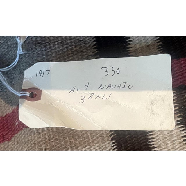 This handmade antique Native American Navajo rug from the early 1900s is a profound piece of indigenous artistry. Woven...