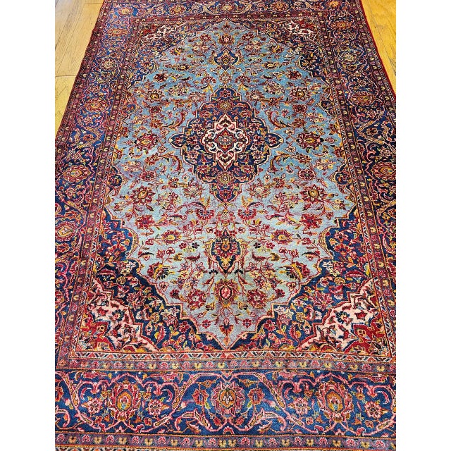 Enjoy the refinement and exquisite beauty of this early 20th century Persian Kashan area rug. This outstanding vintage rug...
