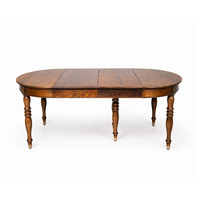 Beautiful antique solid oak extending dining table with a warm, rich patina and elegant turned legs. This versatile piece...