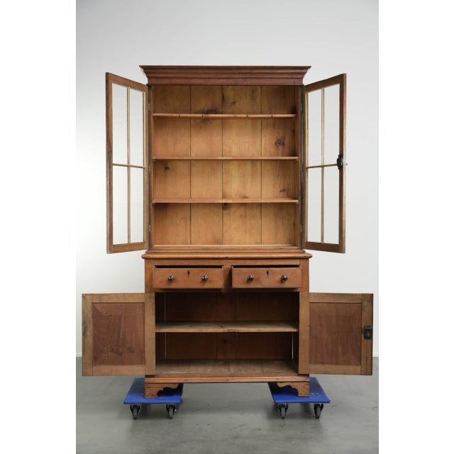 This antique sideboard/bookcase with original glass is made of oak, features warm wood tones, and dates from the 19th...