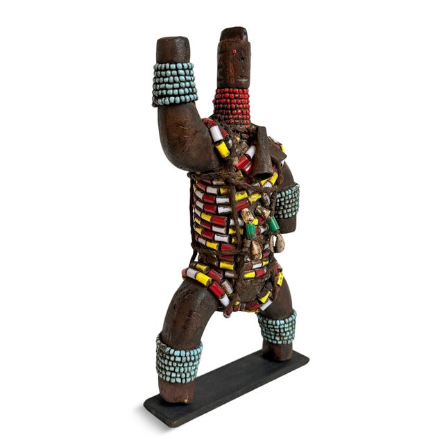 Rich in character and intricate detail, this vintage African carved wooden doll features an expressive sculpted face,...