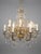 An impressive French brass and crystal chandelier featuring 16 light points and an elegant symmetrical design richly...