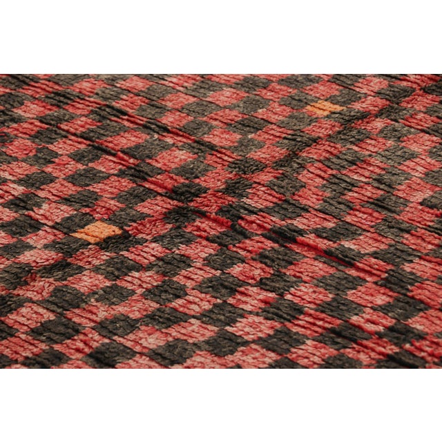 Hand-knotted in wool and originating from Morocco circa 1950-1960, this 6x12 vintage runner rug is among the most exciting...