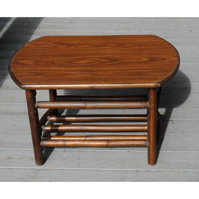Mid Century accent/side table made of sturdy bamboo with a nice oak veneer top. It is rectangle with curved ends. The base...