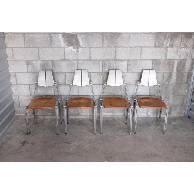 Vintage 1980s cast aluminum and wood dining chairs by Robert Josten. These sculptural chairs feature Josten’s signature...