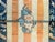 A highly unusual and rare late 19th century Chinese Peking rug with a simple orange and cream striped field with three...