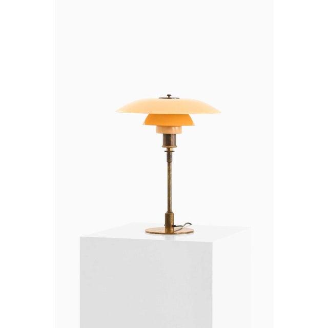 This rare and early table lamp, model ph-4/3, was designed by poul henningsen and produced by louis poulsen in denmark...