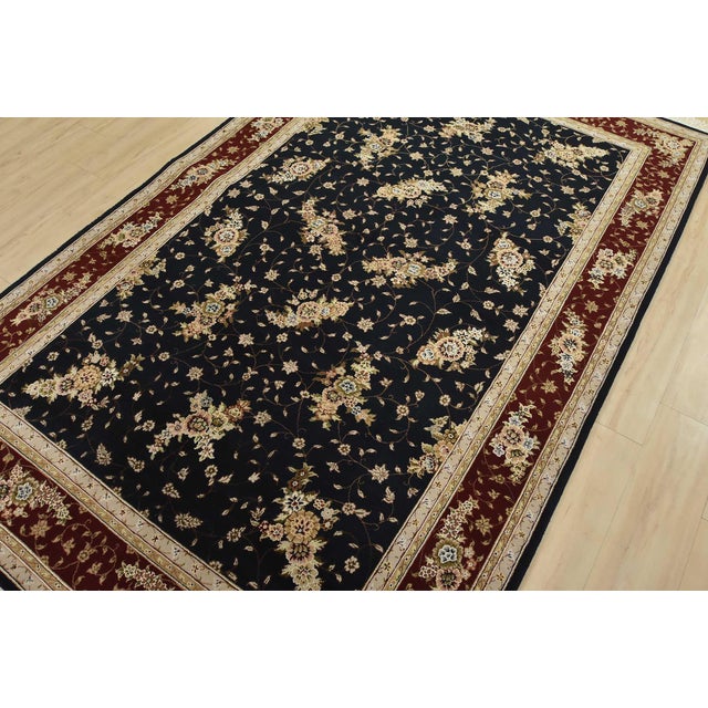 A traditional Tabriz rug hand-knotted with fine wool and silk highlights on a cotton foundation. This intricately woven...