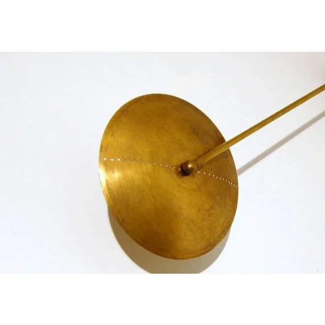 This elegant and refined gold brass wall lamp has been made in the pure tradition of Italian mid-century design. It was...