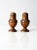 A vintage set of copper salt and pepper shakers, gracefully aged with a warm patina that highlights their hand-crafted...
