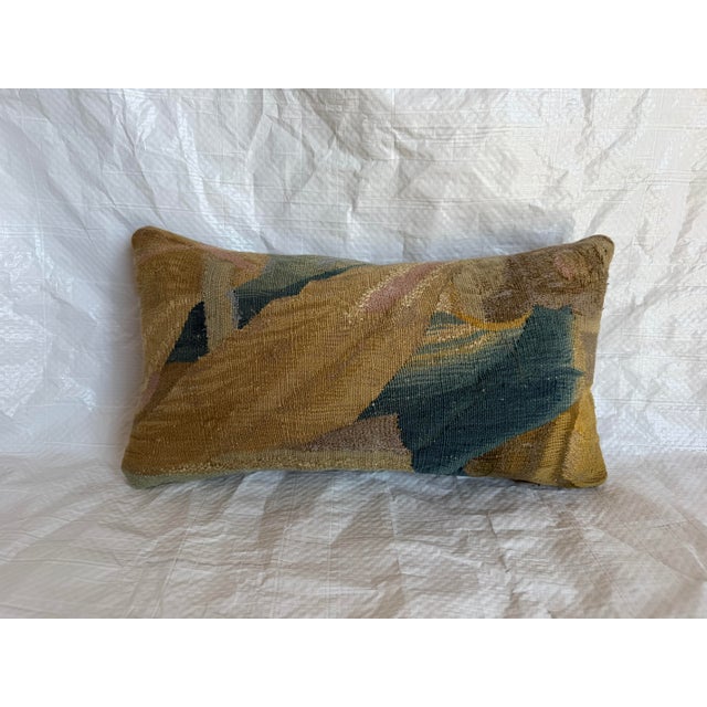 This distinctive antique pillow is created from a 17th-century Brussels wool tapestry fragment, preserving a portion of a...