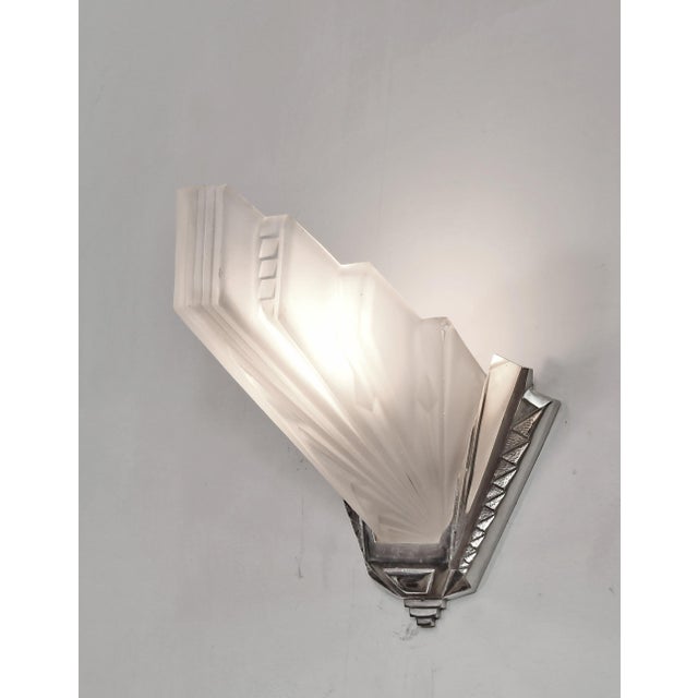 Hubert Petitot A pair of French art deco wall sconces in nickel plated bronze by Petitot. Made around 1935. They hold...