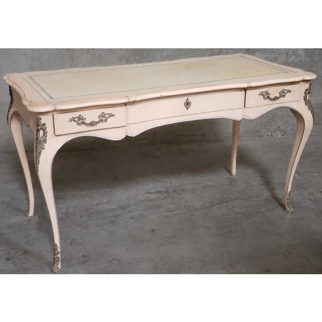 An exceptional John Widdicomb leather-top writing desk finished in a rare custom blush pink decorative scheme. Acquired...