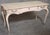 An exceptional John Widdicomb leather-top writing desk finished in a rare custom blush pink decorative scheme. Acquired...
