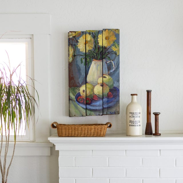 This vibrant impressionist still life painting is a kitchen table scene featuring a plate of apples and strawberries in...