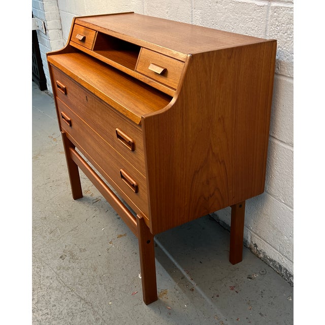 Beautiful mid-century Danish modern teak secretary desk featuring sleek Scandinavian lines, elevated styling, and...