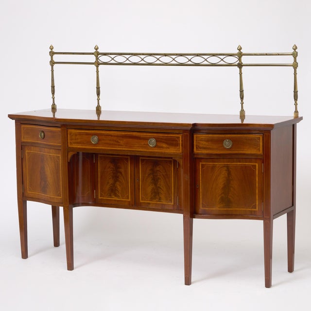 This exceptional Antique English George III inlaid sideboard, crafted in the early 19th century, is a superb example of...