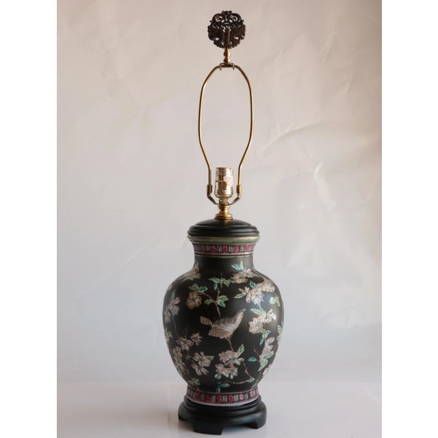 Vintage Chinoiserie porcelain vessel with matte black finish decorated with glossy flowers and songbirds. Original wiring...