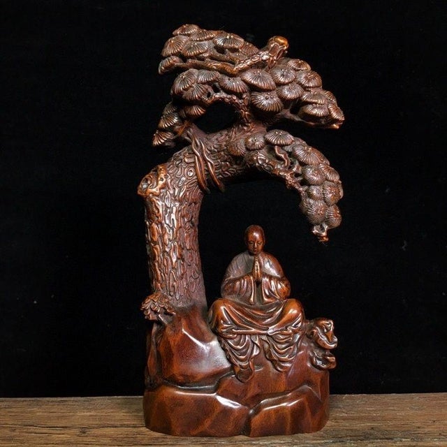 A beautifully hand-carved Boxwood sculpture featuring a seated Buddhist monk or Arhat in a meditative pose with hands...