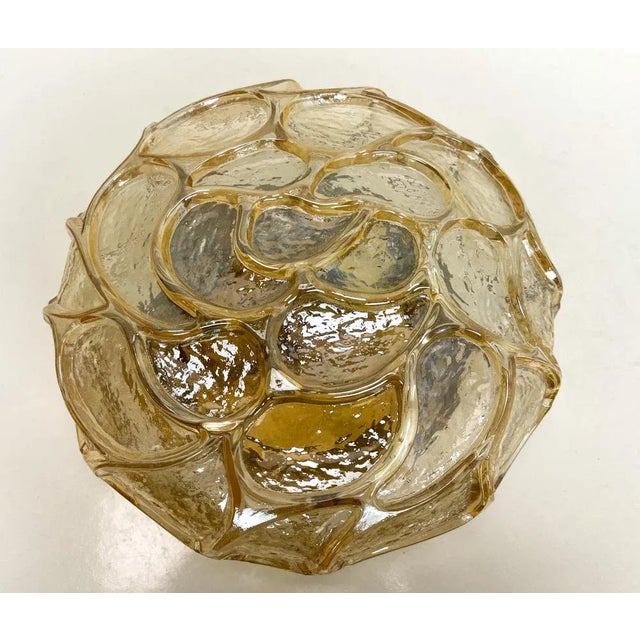 Wonderful Mid Century textured amber glass flush mount lamp with “paisley” motifs. One lamp socket porcelain In a good and...