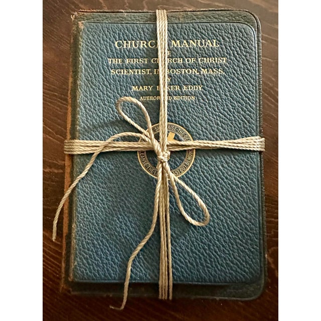 Three Christian Science books wrapped in twine rope. Dark blue with gold lettering. Published 1919, 1934 & 1936. Two are...