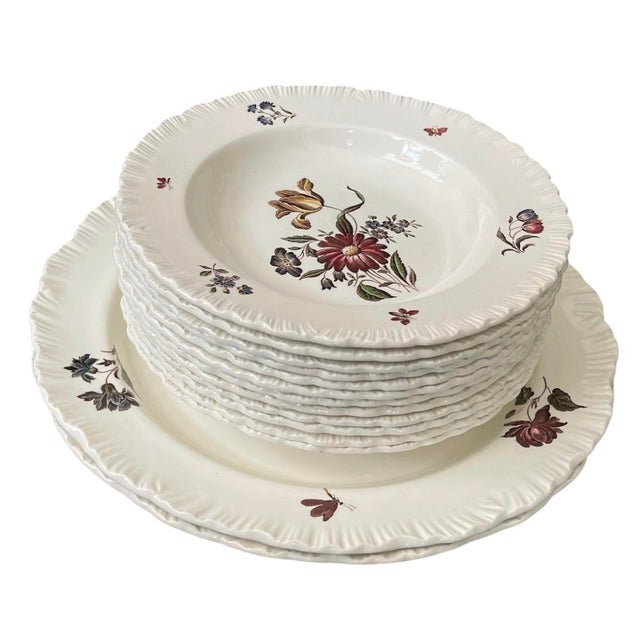Elevate your tablescape with this exceptionally charming antique ceramic dinner service from Wedgwood’s historic Etruria...