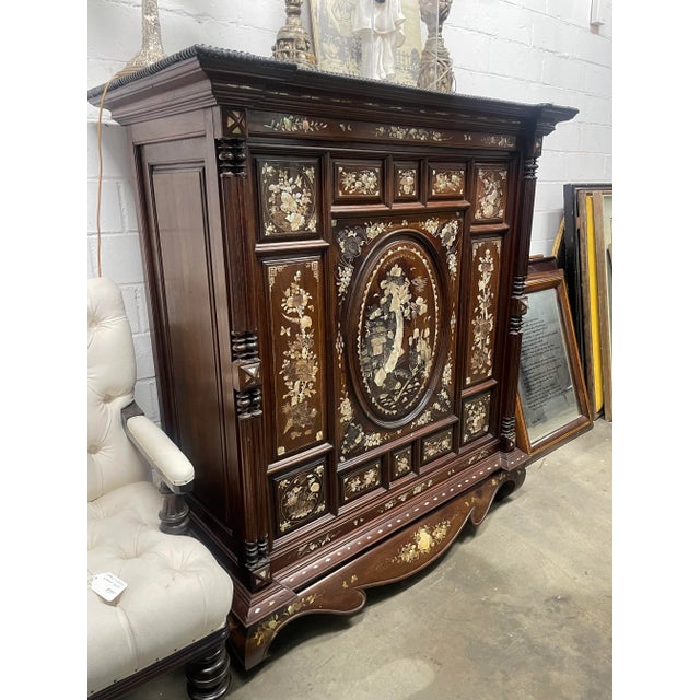 A Dutch Indonesian cabinet from the Mid-19th century. This piece is signed by Van Vuong Hien. It's made of special...