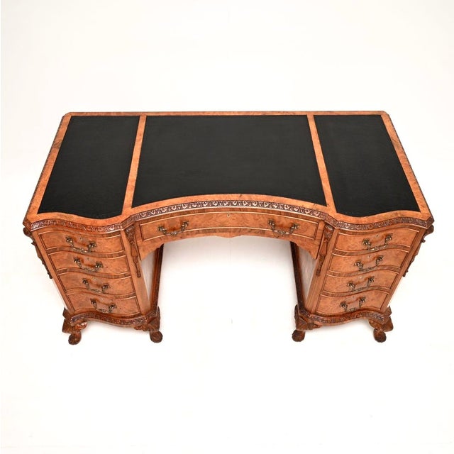 An exceptional antique burr walnut leather top pedestal desk. This is in the Queen Anne style, it dates from around the...