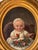 Stunning antique Victorian portrait of a baby painted in oil with a golden oval ornate canvas. The painting features a...