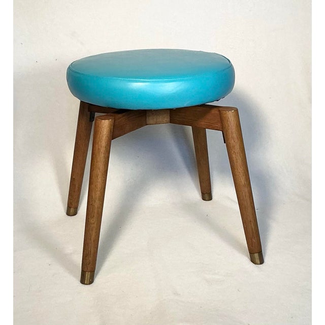 Vintage Mid Century Modern vanity sitting stool, newly reupholstered in teal/blue vinyl. This fabulous stool features a...