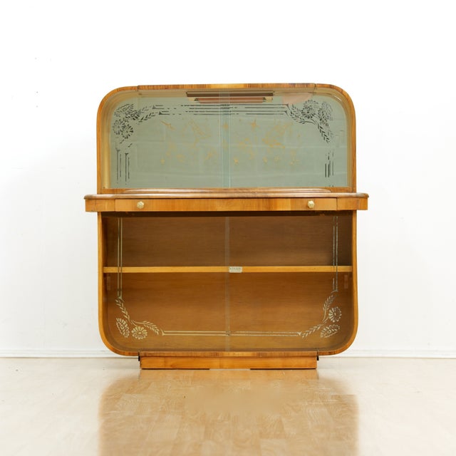 This fabulous mid century liquor cabinet was in England during the 1950s. Produced in Walnut, this fantastic bar is a...
